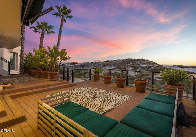 deck at dusk featuring an outdoor living space