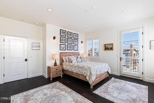 bedroom with dark wood-type flooring and access to outside