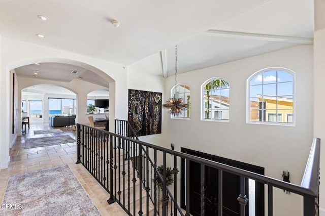 corridor featuring a chandelier and a wealth of natural light