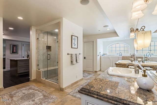 bathroom featuring vanity and a shower with shower door