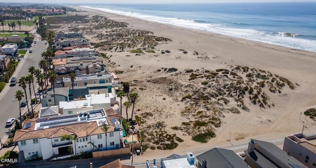 birds eye view of property featuring a view of the beach and a water view