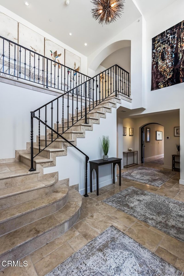 stairs featuring a towering ceiling