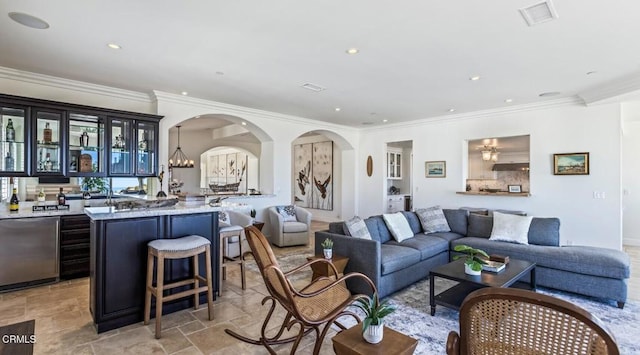 living room with a notable chandelier and ornamental molding