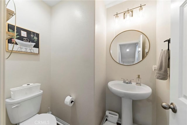 bathroom featuring sink and toilet