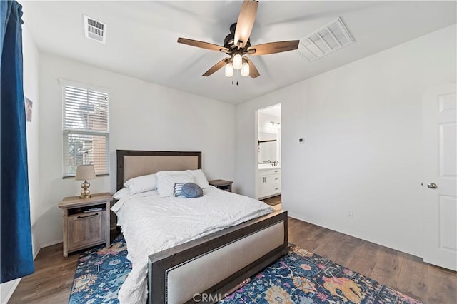 bedroom featuring connected bathroom, dark wood-type flooring, and ceiling fan