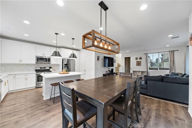 dining room with light hardwood / wood-style flooring