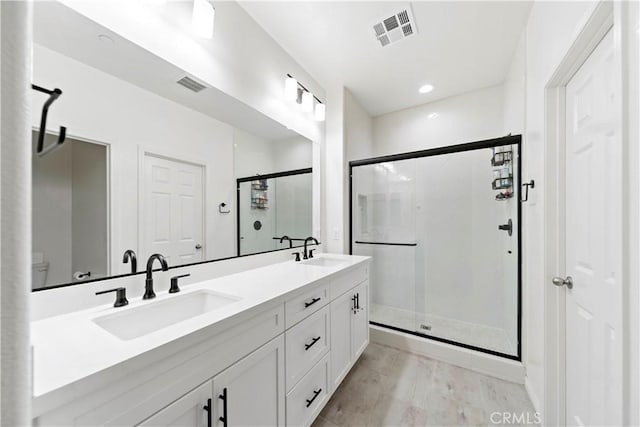 bathroom with vanity, an enclosed shower, hardwood / wood-style flooring, and toilet