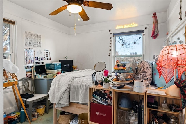 bedroom with ceiling fan and multiple windows