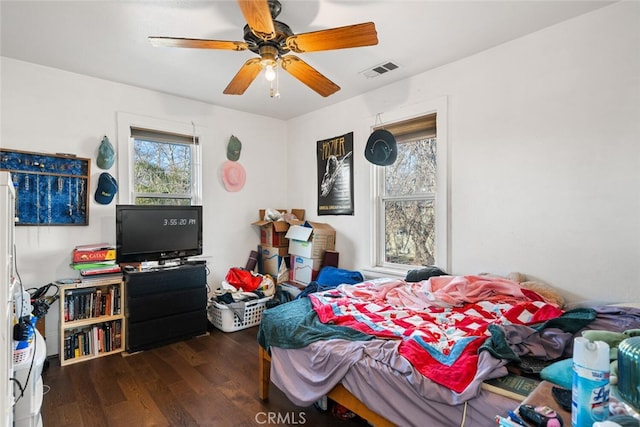 bedroom with ceiling fan and dark hardwood / wood-style floors