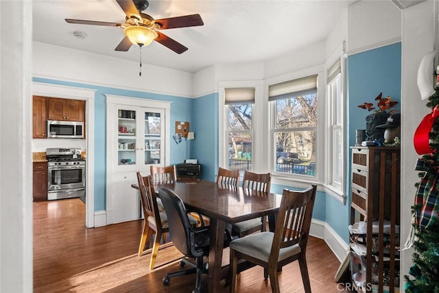 dining room with hardwood / wood-style floors and ceiling fan