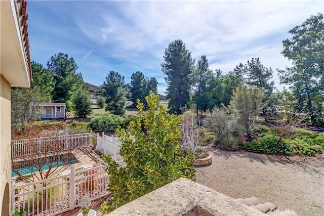 view of yard featuring a patio area, a fenced backyard, and an outdoor structure