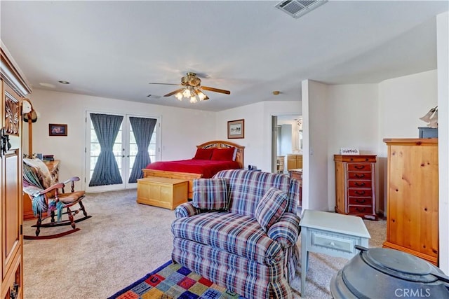 bedroom featuring carpet floors, access to outside, visible vents, and a ceiling fan