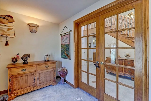 doorway with french doors and baseboards