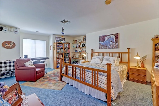 carpeted bedroom featuring visible vents and baseboards