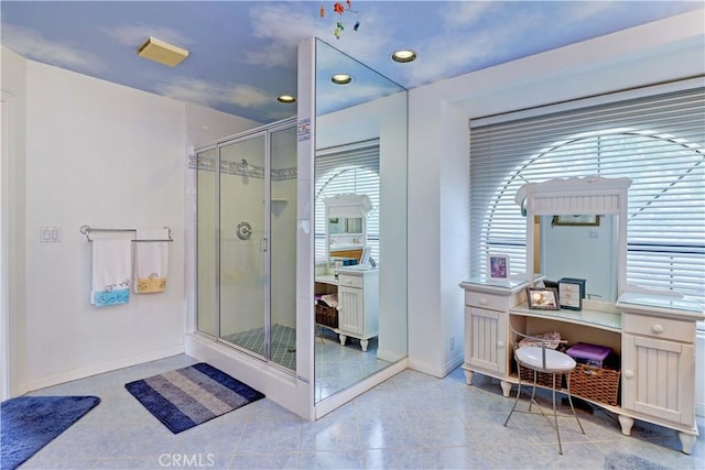 bathroom featuring a stall shower, baseboards, and tile patterned floors