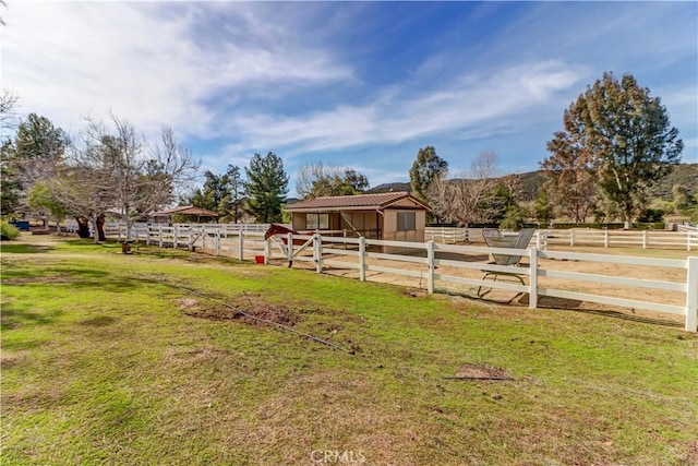 view of yard featuring a rural view and an exterior structure