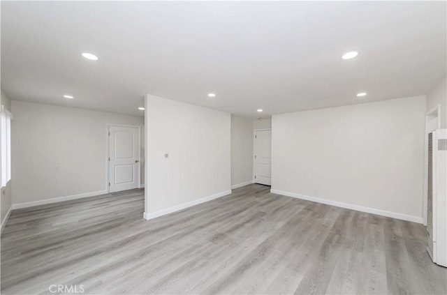 spare room featuring light wood-type flooring