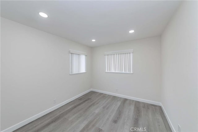 unfurnished room with light wood-type flooring