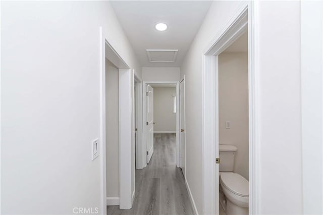 corridor with light hardwood / wood-style floors