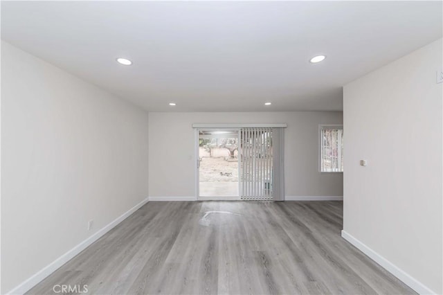 unfurnished room with light wood-type flooring