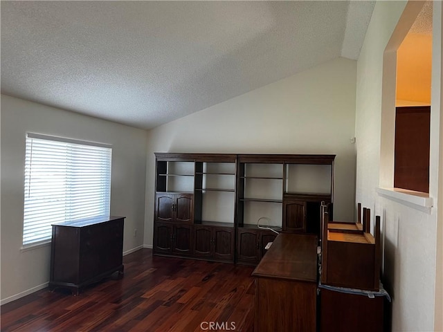 unfurnished office with lofted ceiling, dark hardwood / wood-style floors, and a textured ceiling