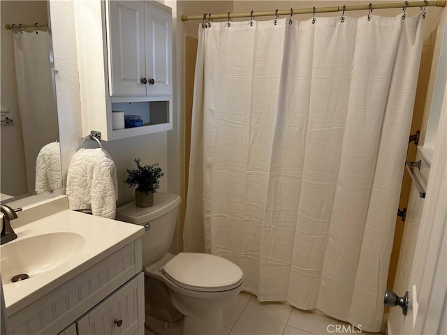 bathroom featuring tile patterned flooring, vanity, and toilet