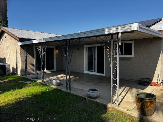 back of house featuring a yard, a patio, and central air condition unit