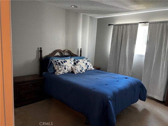 bedroom featuring light carpet and a textured ceiling