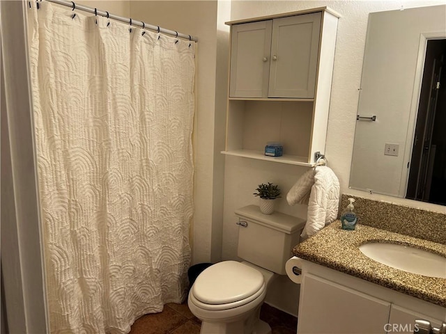 bathroom with vanity, tile patterned floors, and toilet