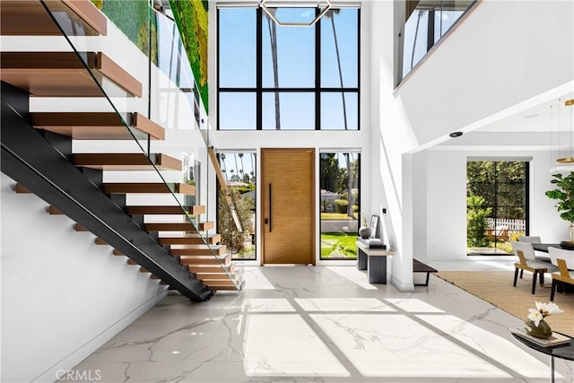 foyer featuring a towering ceiling