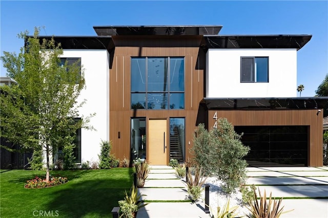 contemporary house featuring a garage and a front yard