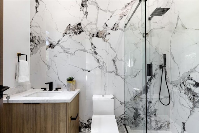 bathroom with vanity, toilet, and a shower