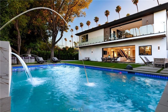 view of swimming pool with a patio and pool water feature