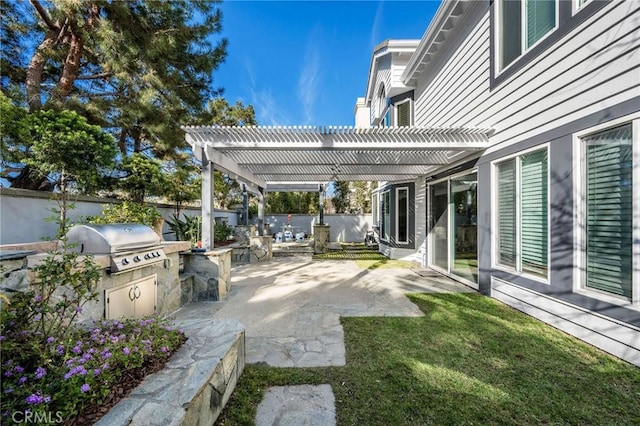 view of patio featuring an outdoor kitchen, a fenced backyard, a pergola, and a grill