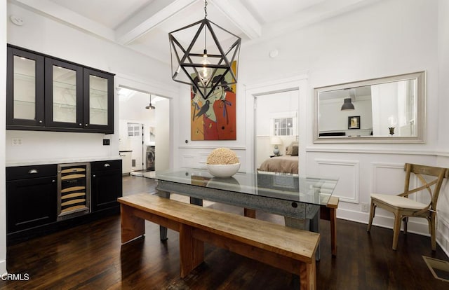 dining area featuring dark hardwood / wood-style floors, beamed ceiling, indoor bar, wine cooler, and a notable chandelier