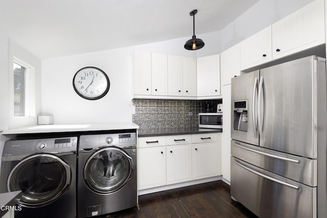 laundry room with dark hardwood / wood-style floors and separate washer and dryer