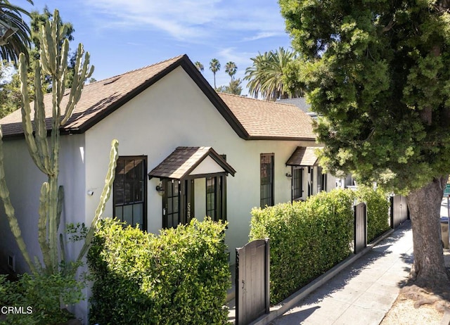 view of home's exterior featuring a shingled roof and stucco siding