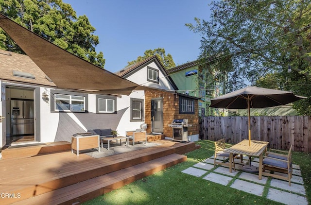 back of house featuring a wooden deck, stucco siding, fence, and a patio area