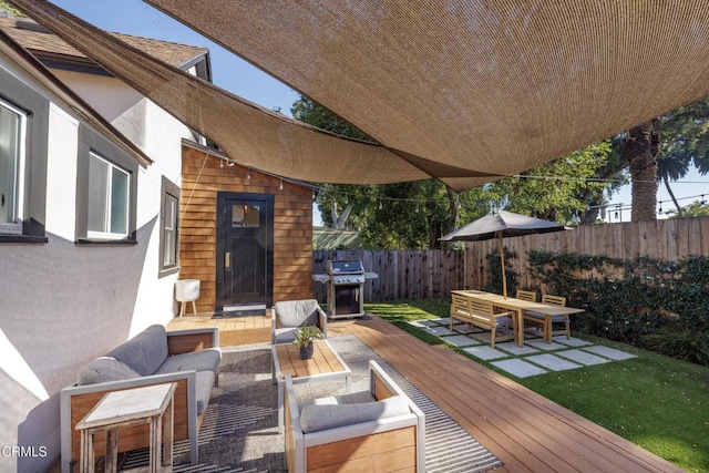 wooden deck with area for grilling, fence, and outdoor lounge area