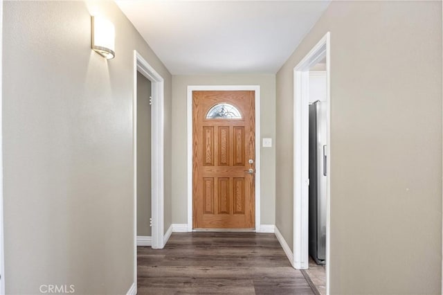 foyer entrance with baseboards and wood finished floors