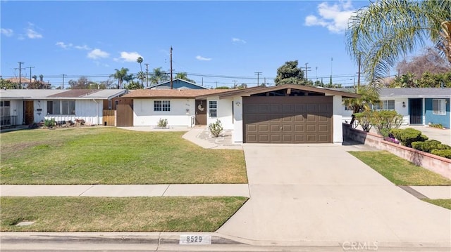 ranch-style home featuring a garage, a front yard, driveway, and stucco siding