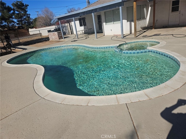 view of pool featuring a patio area and an in ground hot tub