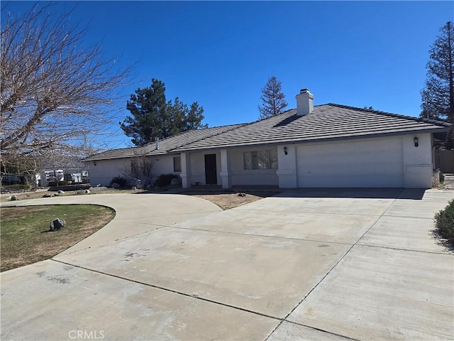 ranch-style house featuring a garage, a tile roof, concrete driveway, and stucco siding