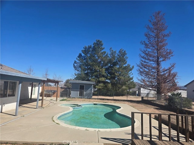 view of pool with a fenced in pool, an outbuilding, a patio area, and a fenced backyard