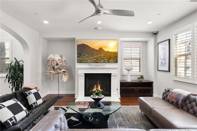 living room featuring wood-type flooring and ceiling fan