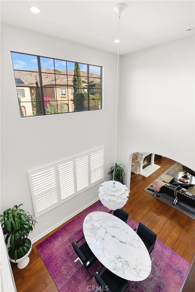 dining room with baseboards, wood-type flooring, and recessed lighting