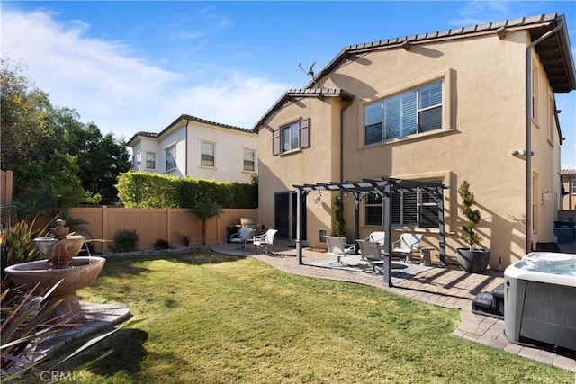 rear view of house featuring a patio, a pergola, fence, and stucco siding