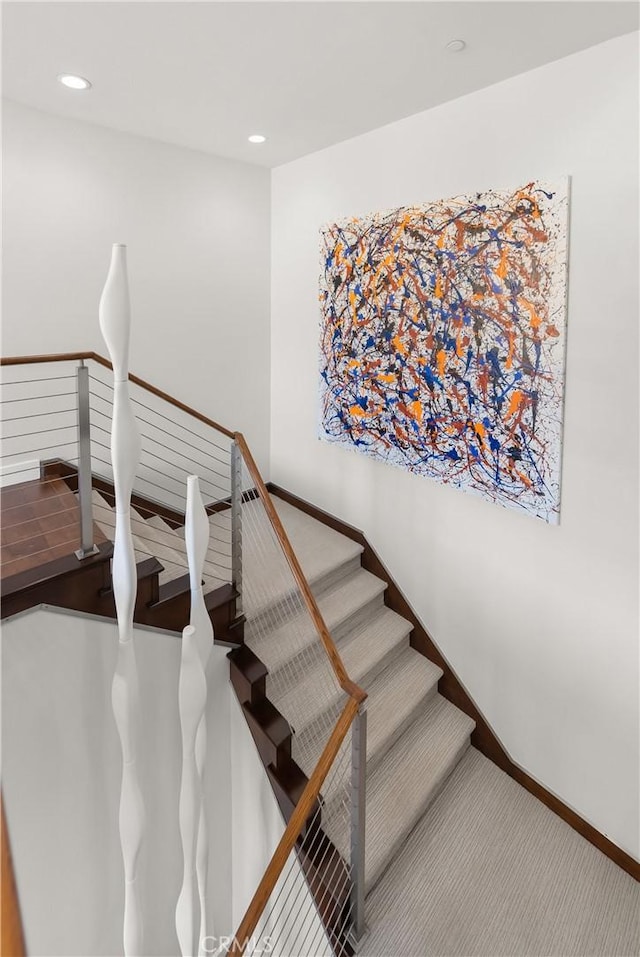 stairway featuring carpet floors, recessed lighting, and baseboards