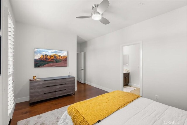 bedroom with dark wood-type flooring, connected bathroom, and ceiling fan