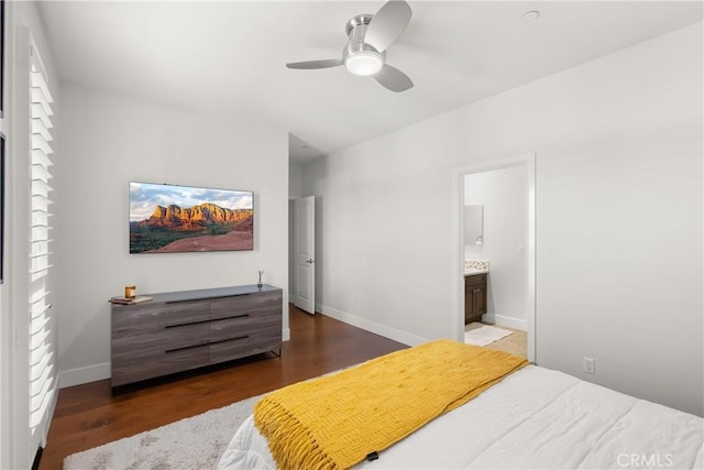 bedroom featuring baseboards, dark wood finished floors, a ceiling fan, and ensuite bathroom